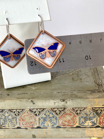 Blue Butterfly Earrings with a White Background in Copper