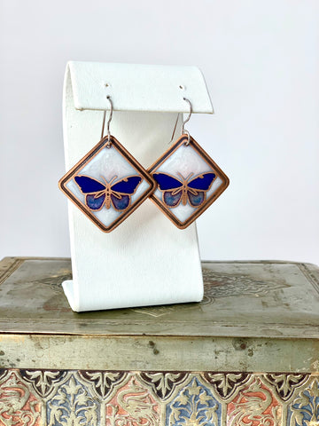 Blue Butterfly Earrings with a White Background in Copper